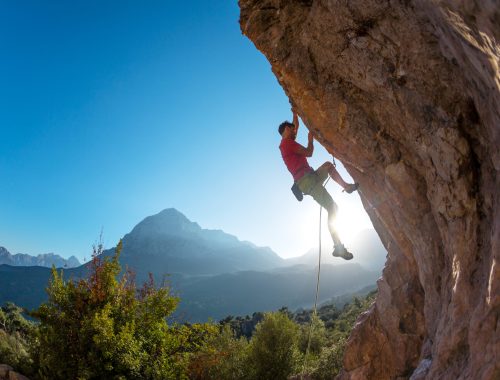 athletic-man-climbs-an-overhanging-rock-with-rope-2026-01-11-10-04-21-utc